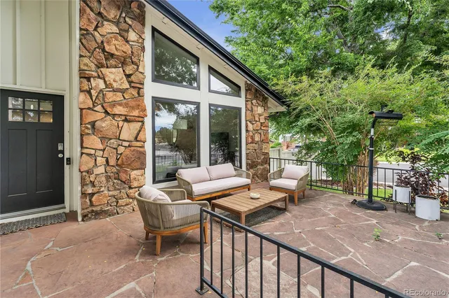 a view of a patio with couple of chairs and a fire pit