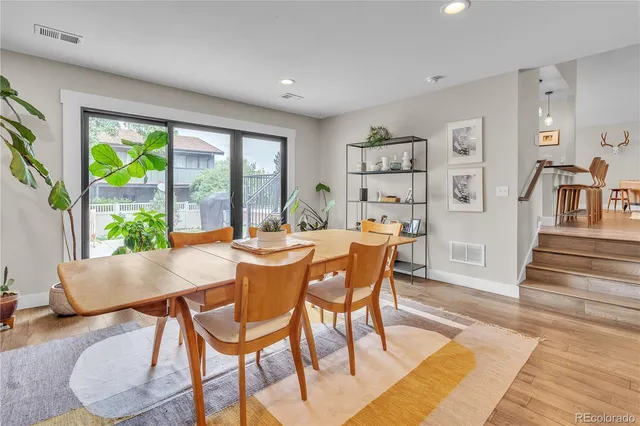a dining room with furniture and wooden floor