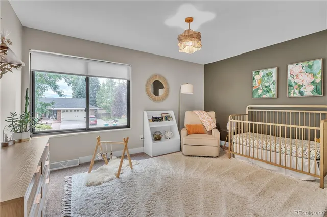 a bedroom with furniture and a large window