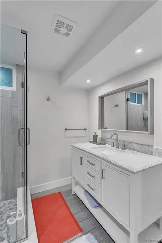 a bathroom with a granite countertop sink mirror and double