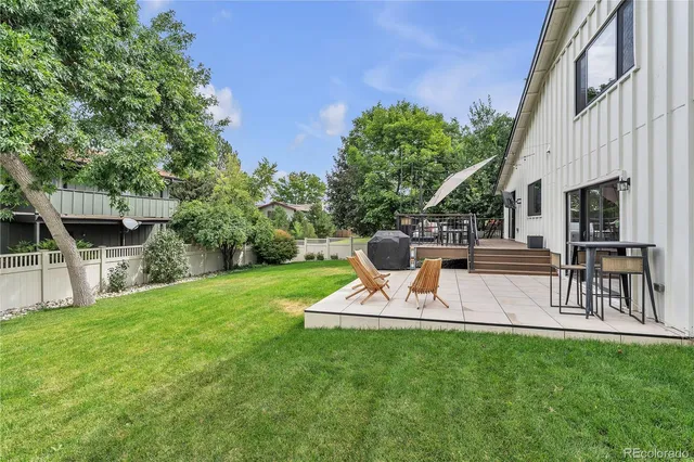 a view of a backyard with sitting area