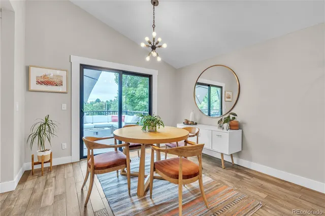 a workspace with wooden floor a glass table and chair