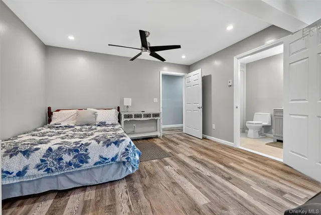 a bedroom with a large bed and a chandelier