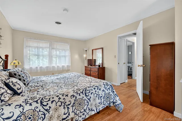 a bedroom with a large bed and a dresser