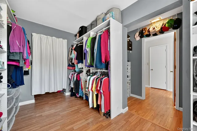 a view of walk in closet with clothes