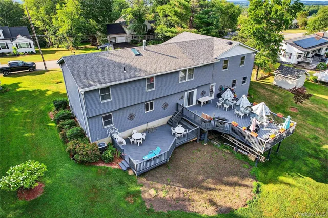 an aerial view of a house with swimming pool garden and patio