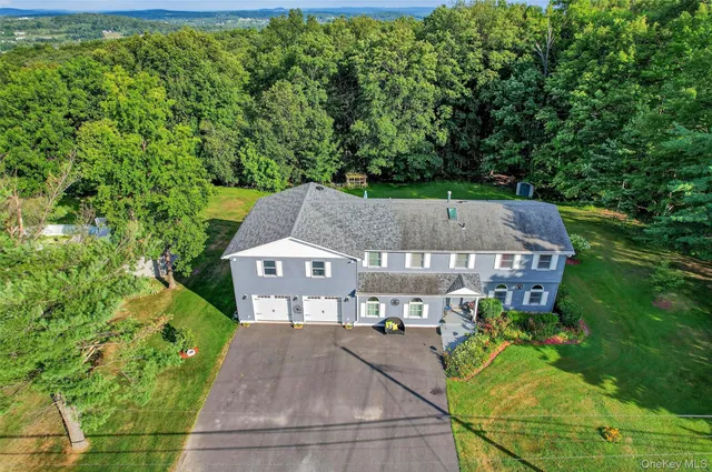 an aerial view of a house with yard patio and green space
