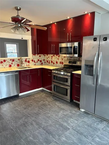 a kitchen with stainless steel appliances a sink and a refrigerator