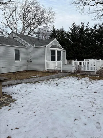 a view of a grey house with a yard