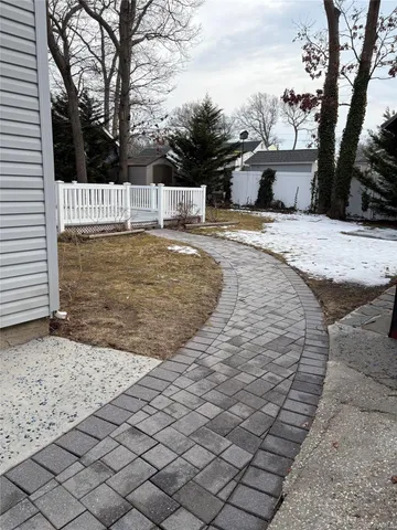 a view of a dry yard with wooden fence