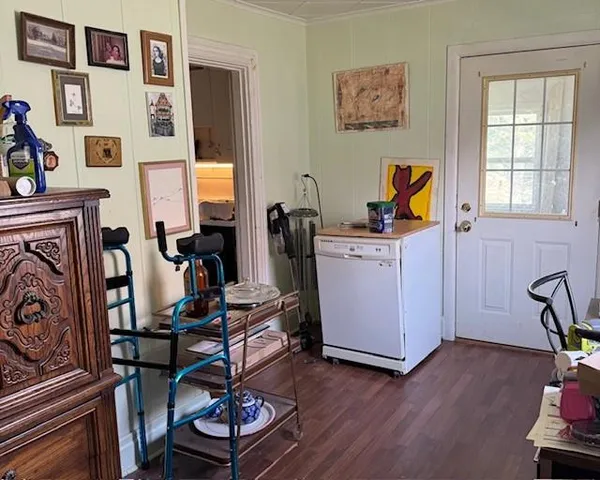 a view of a workspace with furniture and a window