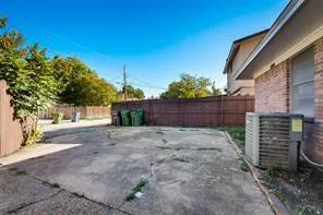 a view of backyard and wooden fence