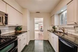 a kitchen with a sink stove and cabinets