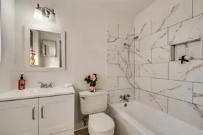 a bathroom with a sink toilet and shower