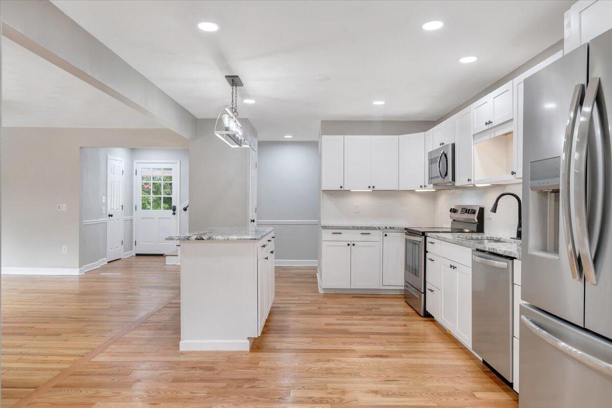 422 Willow Creek Road Rocky Mount, VA 24151 - Photo 19 of 70 a kitchen with white cabinets and stainless steel appliances