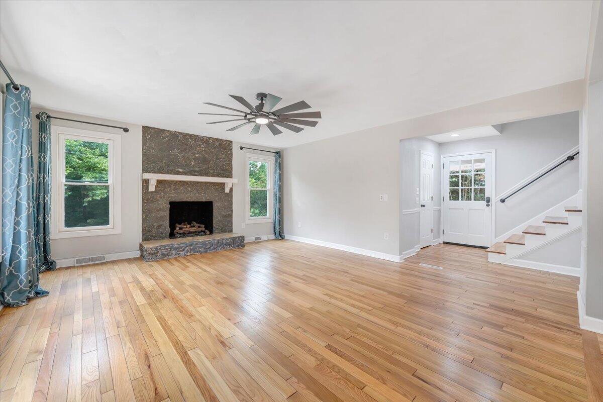 422 Willow Creek Road Rocky Mount, VA 24151 - Photo 10 of 70 a view of an empty room with wooden floor fireplace and a window