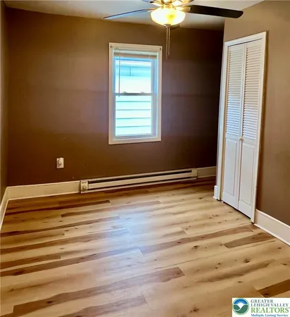 a view of room with window and wooden floor