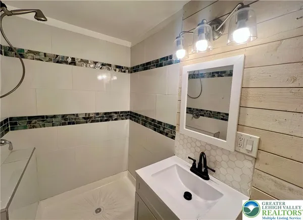 a bathroom with a sink and mirror