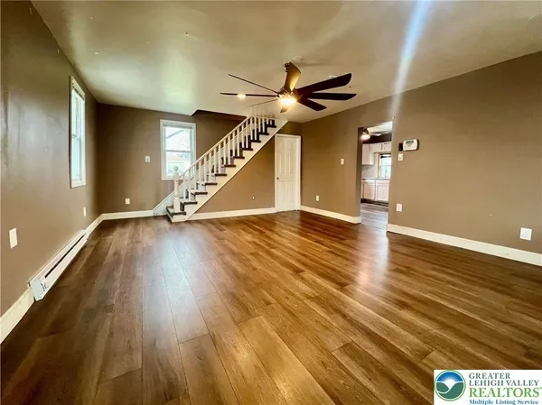 a view of an empty room with wooden floor