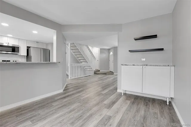 a view of a kitchen with a sink and wooden floor