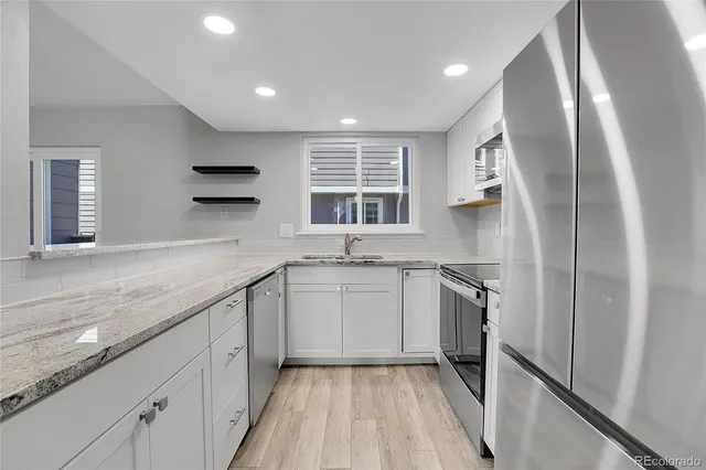 a kitchen with a sink stove and refrigerator