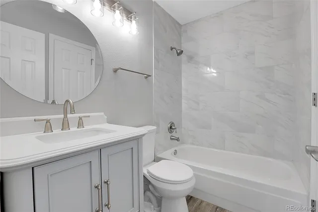 a bathroom with a sink a toilet and bathtub