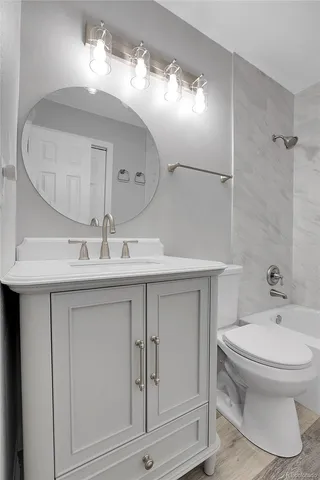a bathroom with a sink a toilet and a mirror