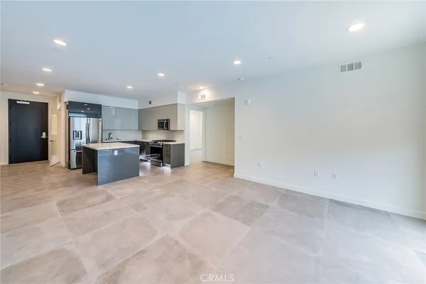 a view of kitchen with refrigerator and a stove top oven
