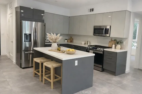 a kitchen with a sink stove and refrigerator