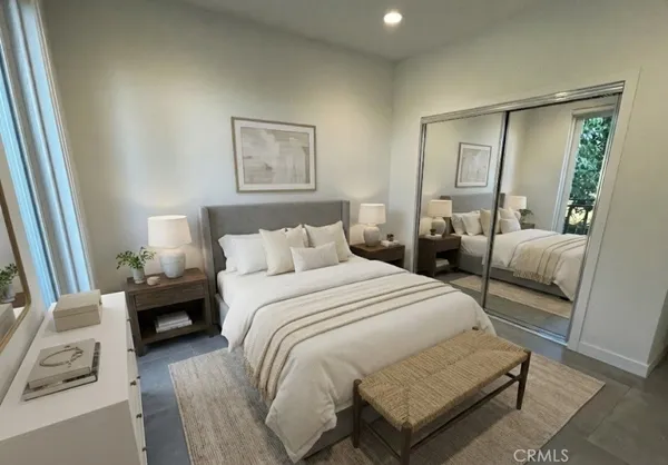 a bedroom with a bed and a couch