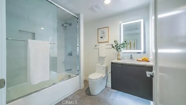 a bathroom with a tub sink and mirror