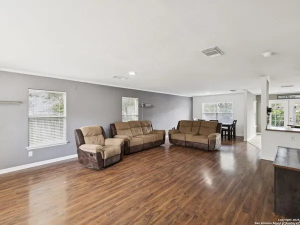a living room with furniture and stairs