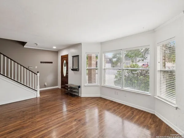 a view of a livingroom with furniture wooden floor and window