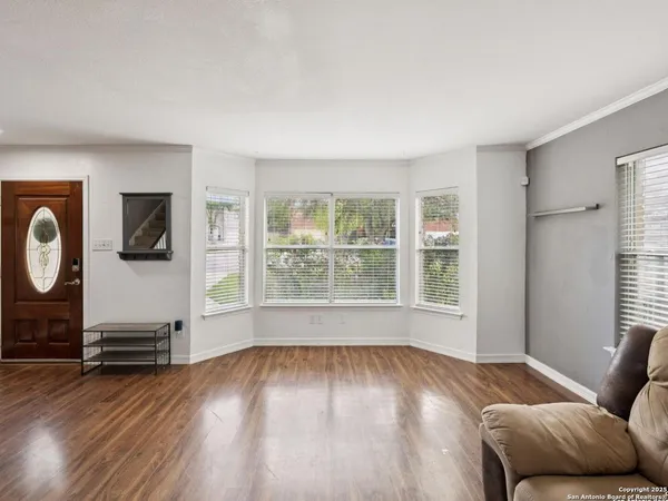 a living room with furniture and wooden floor