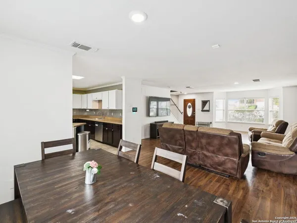 a view of a dining room with furniture and wooden floor