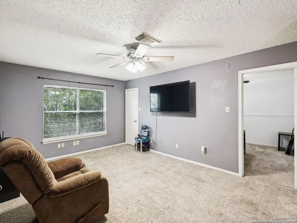 a living room with furniture and a book shelf