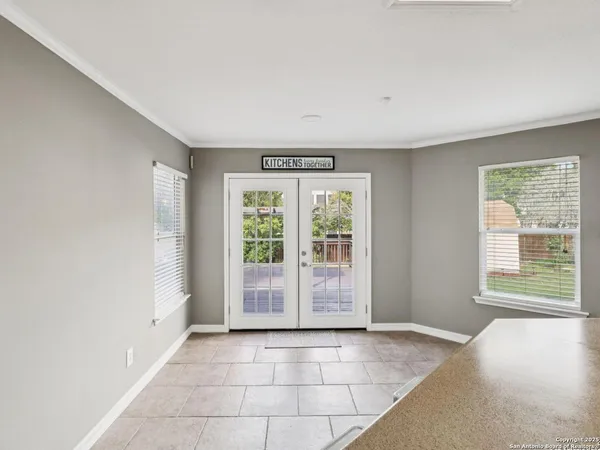 a kitchen with a sink a stove and chairs