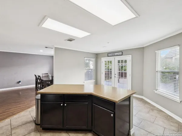 a kitchen with a sink a stove and cabinets