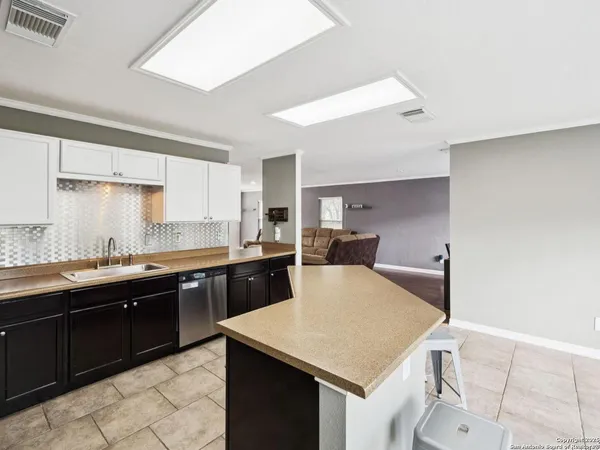 a kitchen with a sink a stove a microwave and refrigerator