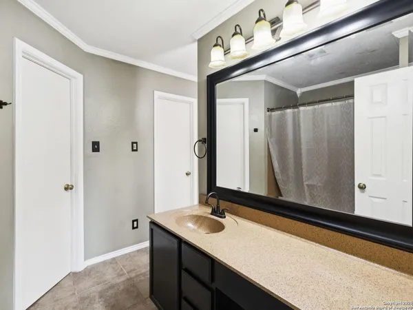 a bedroom with a bed and large windows