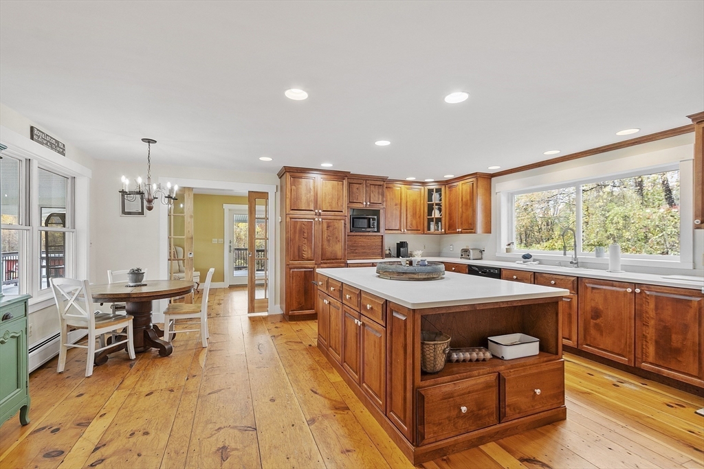 4 Elm Avenue Royalston, MA 01368 - Photo 18 of 42 a kitchen with a stove a refrigerator a dining table and chairs with wooden floor