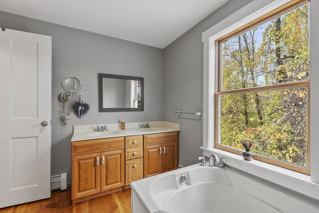 4 Elm Avenue Royalston, MA 01368 - Photo 33 of 42 a bathroom with a tub sink and mirror