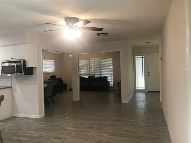 a view of a livingroom with furniture and a ceiling fan