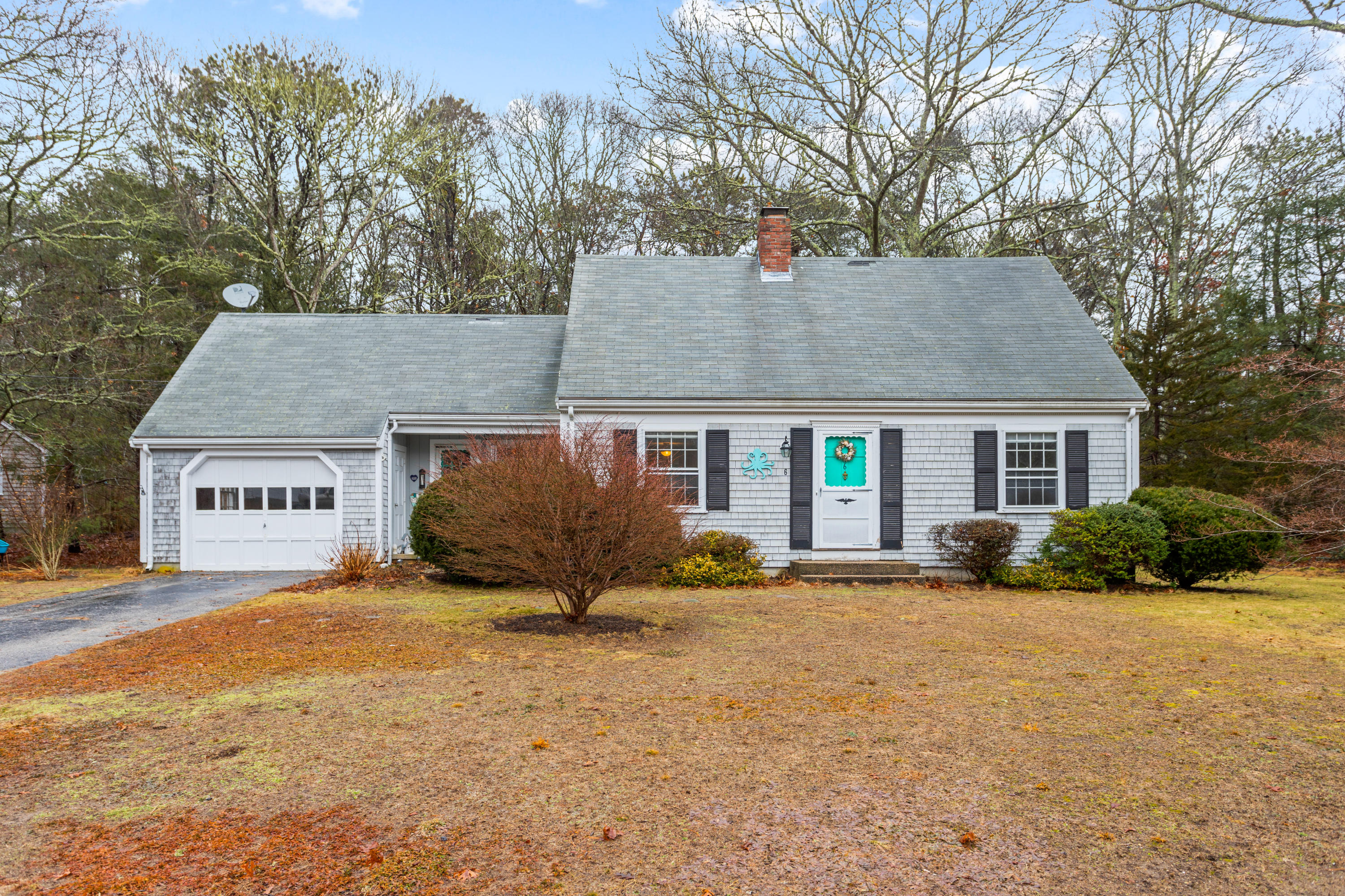 a view of a house with a yard covered in snow