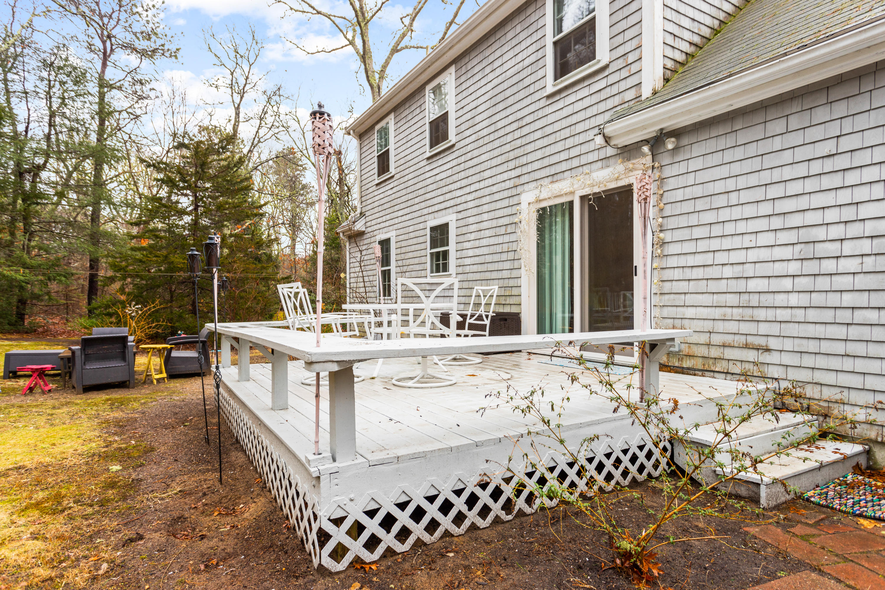 6 Padlock Lane Centerville, MA 02632 - Photo 24 of 29 a view of a white house with a bench