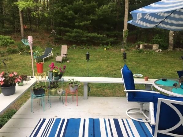 6 Padlock Lane Centerville, MA 02632 - Photo 25 of 29 a view of a chairs and table in patio next to a yard