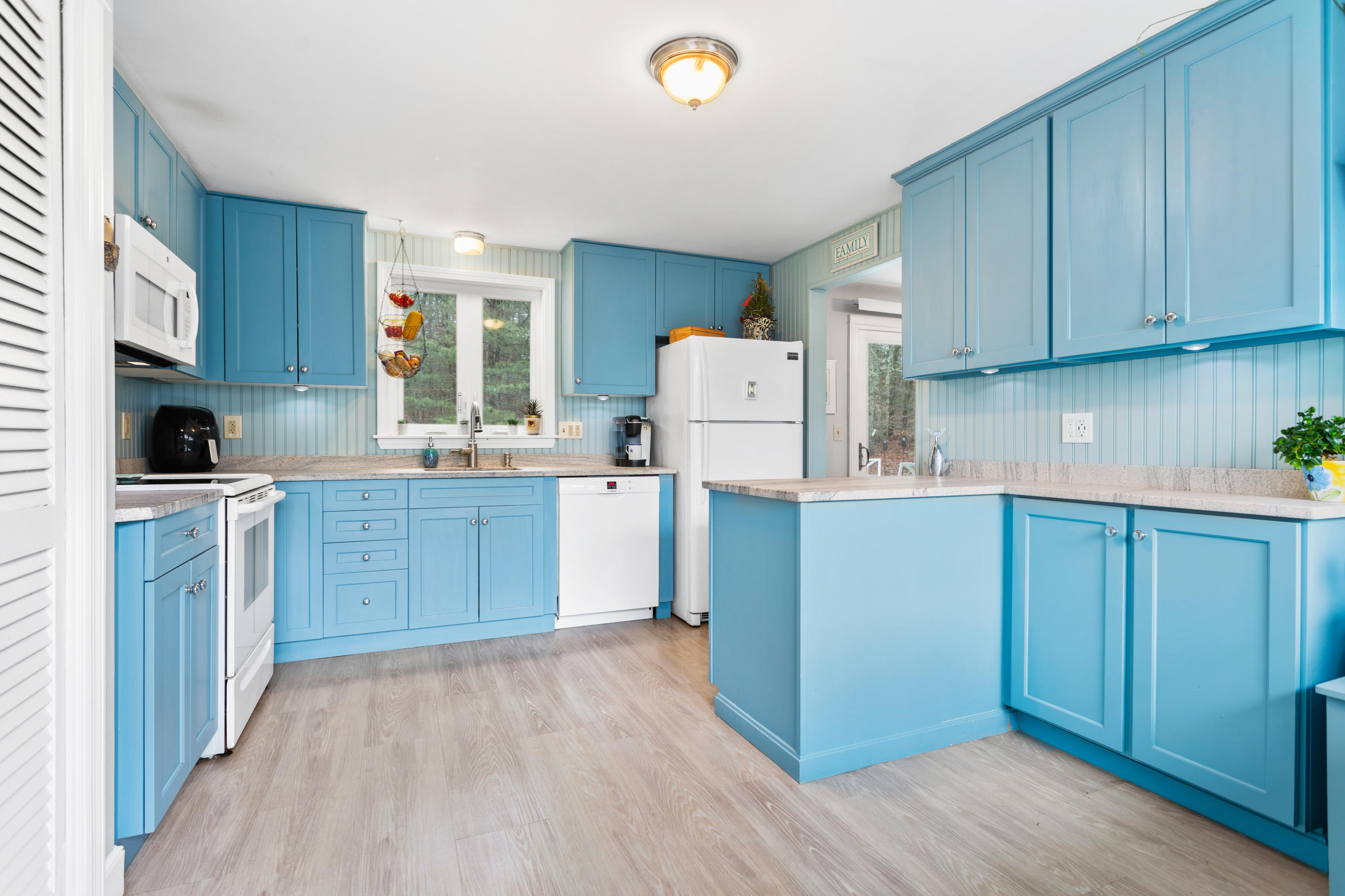 6 Padlock Lane Centerville, MA 02632 - Photo 6 of 29 a kitchen with a refrigerator a stove top oven a sink and dishwasher with wooden floor