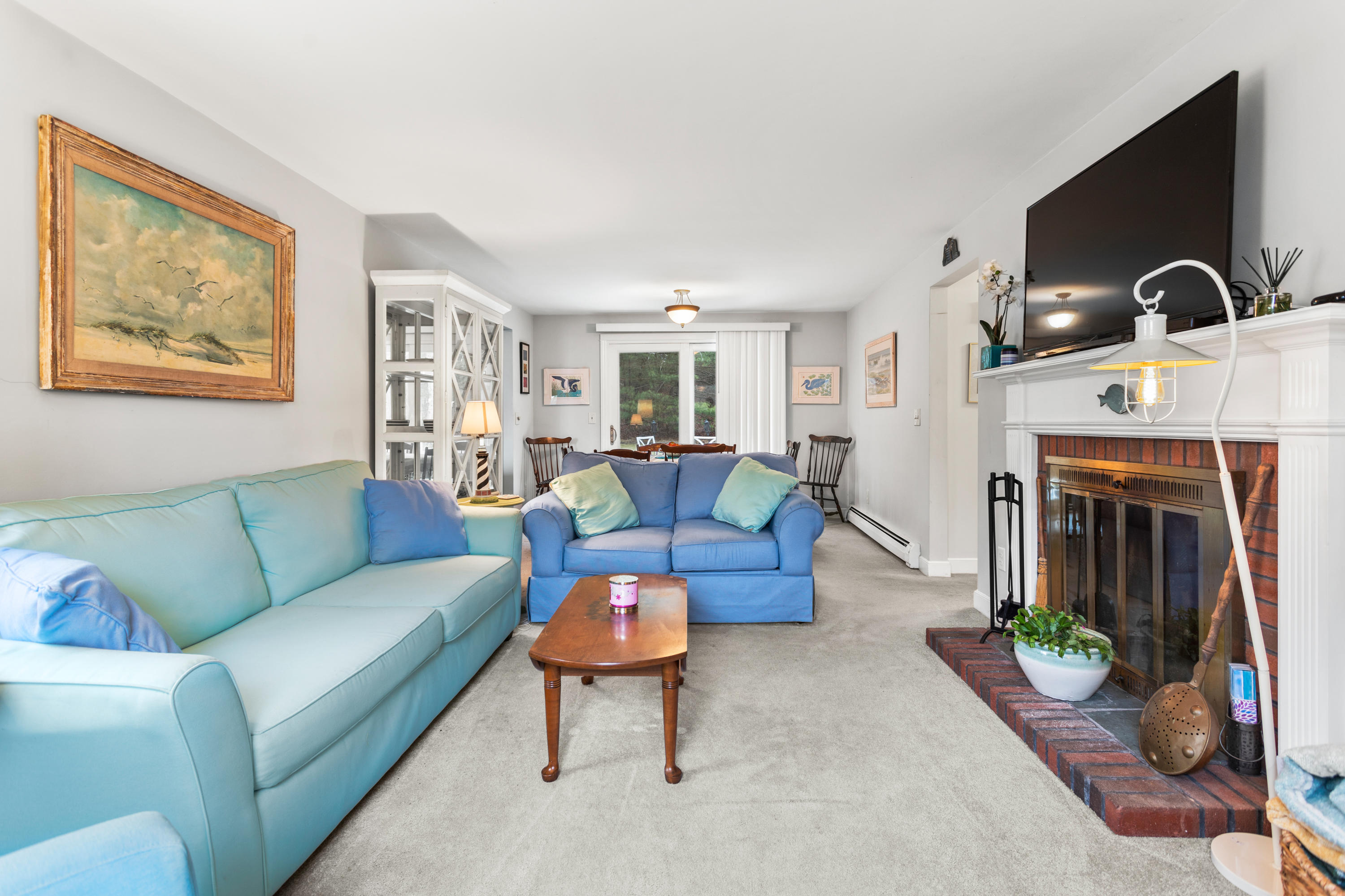 6 Padlock Lane Centerville, MA 02632 - Photo 7 of 29 a living room with furniture a fireplace and a flat screen tv