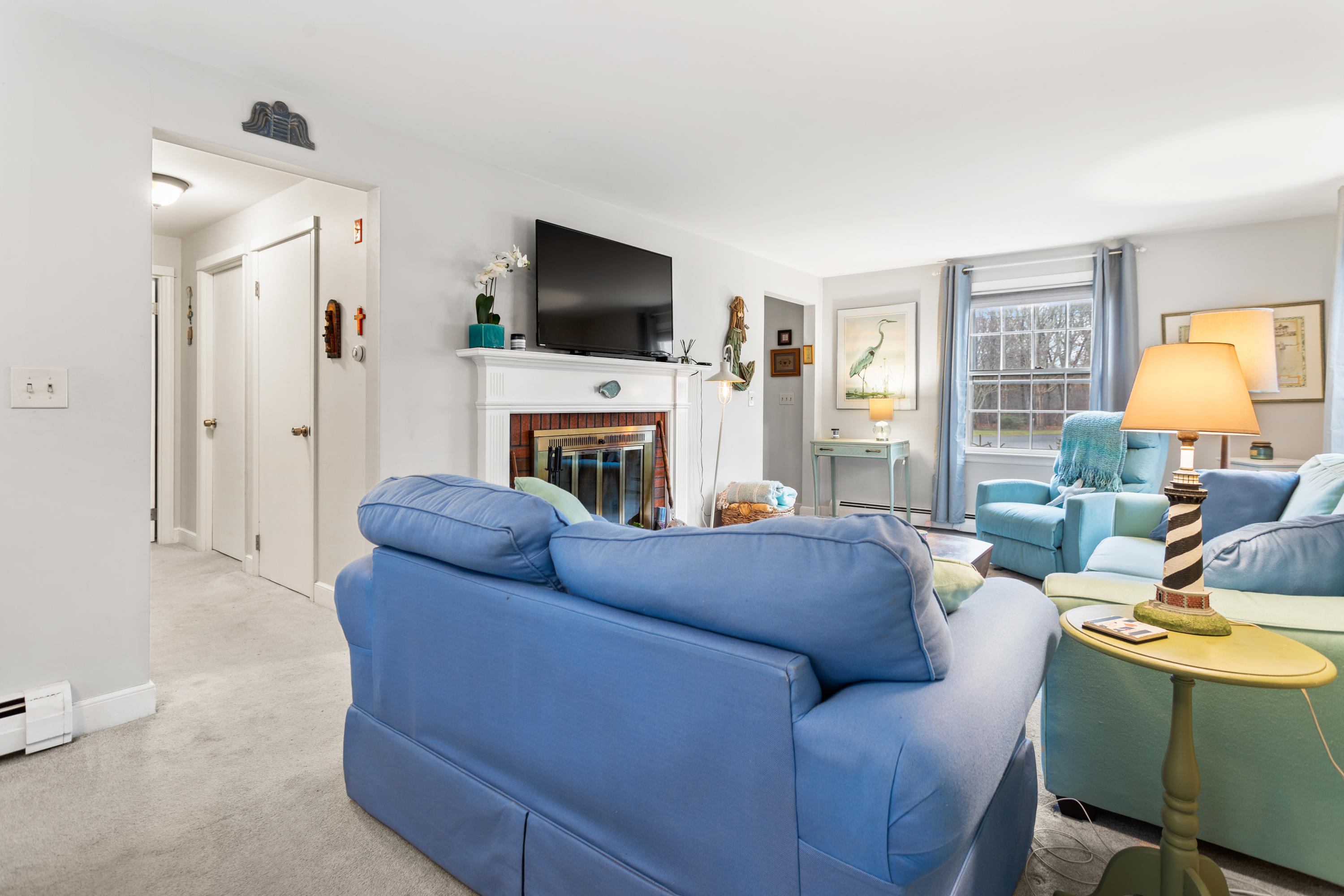 6 Padlock Lane Centerville, MA 02632 - Photo 9 of 29 a living room with furniture a flat screen tv and a fireplace