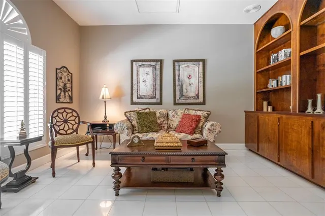 a bed sitting in a bedroom next to a window with a dresser